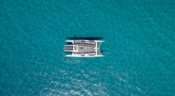 Photo of drone taking water from the boat in the middle of the water