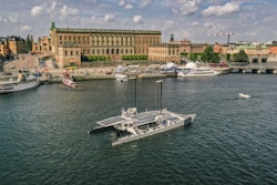 Energy Observer sails in front of the Royal Palace in Stockholm