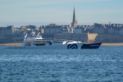 Energy Observer sails with the city of Saint-Malo in the background