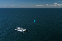The boat offshore being towed by a trailing wing