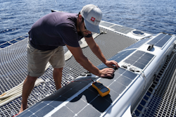 Luc, our systems engineer, measuring the tension of our onboard solar panels